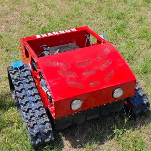 Red SHANNON remote-controlled tracked lawn mower with heavy-duty rubber tracks, front headlights, and ventilation grilles, positioned on green grass for all-terrain slope and garden maintenance
